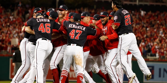 The Washington Nationals celebrate after Game 4 of the baseball National League Championship Series Tuesday, Oct. 15, 2019, in Washington. The Nationals won 7-4 to win the series 4-0. (AP Photo/Jeff Roberson)