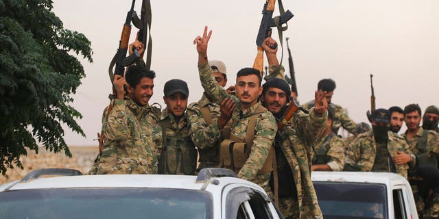 A convoy of Turkish backed Free Syria Army about to cross into Turkey near the town of Azaz, Syria, on Wednesday. (AP Photo)