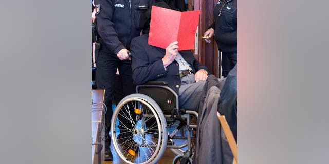 93-year-old former SS guard Bruno Dey in the concentration camp Stutthof near Danzig is sitting in the regional court in Hamburg, Germany, Oct.17, 2019. The prosecution accuses the 93-year-old man of aiding and abetting the murder of 5230 people. The defendant was only 17 or 18 years old at the time of the crime. That's why the trial takes place in front of a juvenile delinquency chamber. About 25 survivors of the concentration camp appear as joint plaintiffs. (Daniel Bockwoldt/dpa via AP)