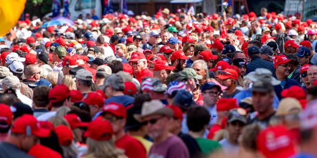 A sea of red hats as supporters of President Trump lined up to enter the campaign rally on Thursday in Dallas. (AP Photo/Jeffrey McWhorter)