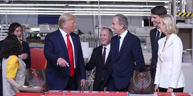 President Donald Trump tours the Louis Vuitton Workshop Rochambeau in Alvarado, Texas, Thursday, Oct. 17, 2019, with Bernard Arnault, chief executive of LVMH, third from right, Alexandre Arnault, second from right and Ivanka Trump. (AP Photo/Andrew Harnik)