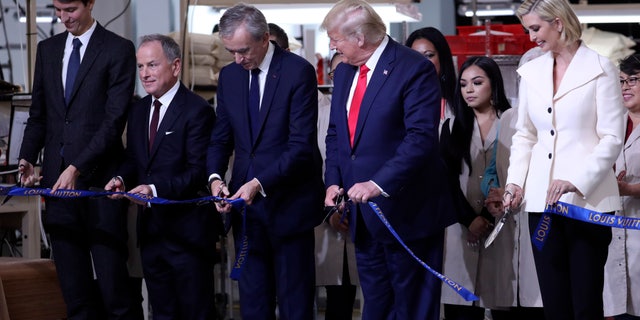 President Donald Trump participates in a ribbon cutting ceremony at the Louis Vuitton Workshop Rochambeau in Alvarado, Texas, Thursday, Oct. 17, 2019, with from left Alexandre Arnault, Michael Burke, Bernard Arnault and Ivanka Trump. (AP Photo/Andrew Harnik)