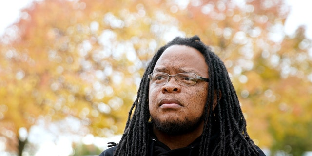 Marlon Anderson poses for a photo Thursday, Oct. 17, 2019 in Madison, Wis. Anderson, a security guard at a Wisconsin high school, was fired after he says he repeated a racial slur while telling a student who had called him that word not to use it. He has filed a grievance seeking his job back.