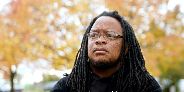 Marlon Anderson poses for a photo Thursday, Oct. 17, 2019 in Madison, Wis. Anderson, a security guard at a Wisconsin high school, was fired after he says he repeated a racial slur while telling a student who had called him that word not to use it. He has filed a grievance seeking his job back.