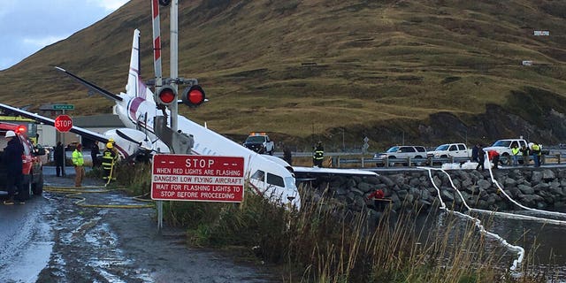 A commuter airplane has crashed near the airport in a small Alaska community on the Bering Sea, Thursday, Oct. 17, 2019, in Unalaska, Alaska. Freelance photographer Jim Paulin says the crash at the Unalaska airport occurred Thursday after 5 p.m. Paulin says the Peninsula Airways flight from Anchorage to Dutch Harbor landed about 500 feet beyond the airport near the water.