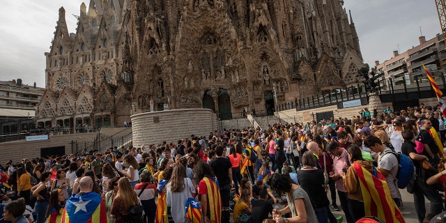 Demonstrators join a pro-independence gathering outside the Sagrada Família basilica during the fifth day of protests over the conviction of a dozen Catalan independence leaders in Barcelona, Spain, Friday, Oct. 18, 2019.