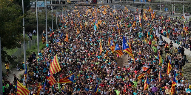 Protesters match into the city on the fifth day of protests over the conviction of a dozen Catalan independence leaders in Barcelona, Spain, Friday, Oct. 18, 2019. (AP Photo/Manu Fernandez)