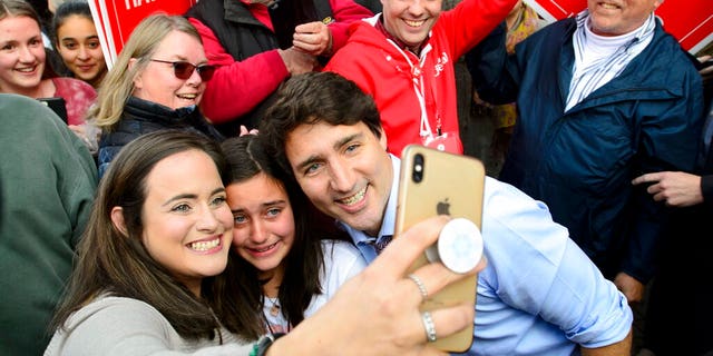 Liberal leader Justin Trudeau pose with supporters during a campaign stop in Orillia, Ontario on Friday Oct. 18, 2019.