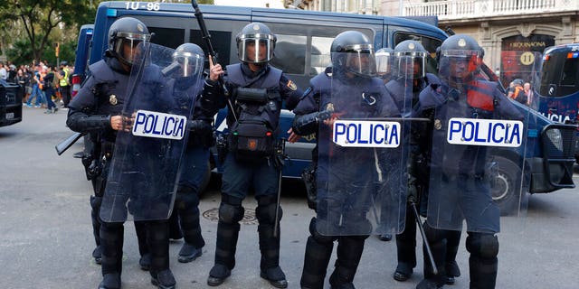 Riot police get ready in Barcelona, Spain, Saturday, Oct. 19, 2019. Barcelona and the rest of the restive Spanish region of Catalonia are reeling from five straight days of violent protests for the sentencing of 12 separatist leaders to lengthy prison sentences.The riots have broken out at nightfall following huge peaceful protests each day since Monday's Supreme Court verdict. (AP Photo/Manu Fernandez)