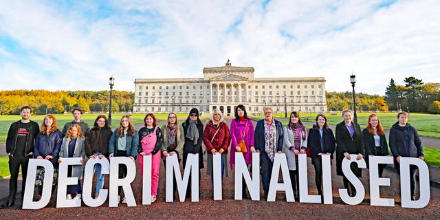 Pro-choice activists take part in a photo call in the grounds of Stormont Parliament, Belfast, Monday Oct. 21, 2019. Abortion is set to be decriminalized and same-sex marriage legalized in Northern Ireland as of midnight, bringing its laws in line with the rest of the U.K. (Niall Carson/PA via AP)