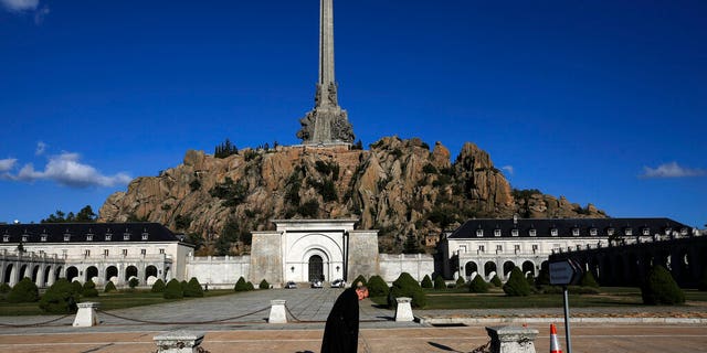 A friar walks in front of The Valley of the Fallen mausoleum near El Escorial, outskirts of Madrid.