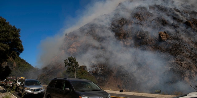 Palisades residents flee the area as a wildfire erupts in the Pacific Palisades area of Los Angeles, Monday, Oct. 21, 2019.