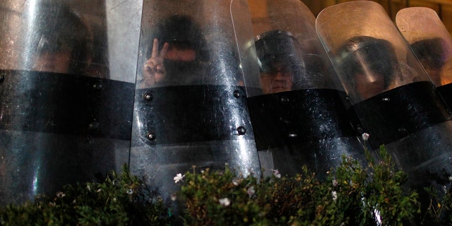 Police block protesters from entering the Supreme Electoral Court where election ballots are being counted in La Paz, Bolivia.