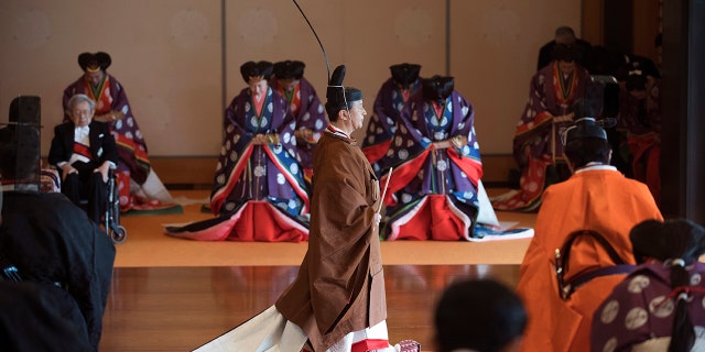 Japan's Emperor Naruhito, center, leaves at the end of the enthronement ceremony where he officially proclaimed his ascension to the Chrysanthemum Throne at the Imperial Palace in Tokyo, Tuesday, Oct. 22, 2019. (Kazuhiro Nogi/Pool Photo via AP)