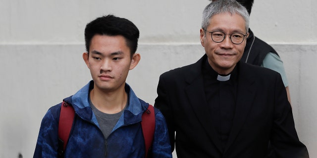 Chan Tong-kai, left, walks out as he is released from prison in Hong Kong Wednesday, Oct. 23, 2019.