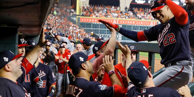 Washington Nationals' Juan Soto celebrates in the dugout after his home run against the Houston Astros during the fourth inning of Game 1 of the baseball World Series Tuesday, Oct. 22, 2019, in Houston. (AP Photo/Matt Slocum)