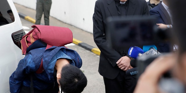Chan Tong-kai, left, bows after talking to the media as he is released from prison in Hong Kong Wednesday.