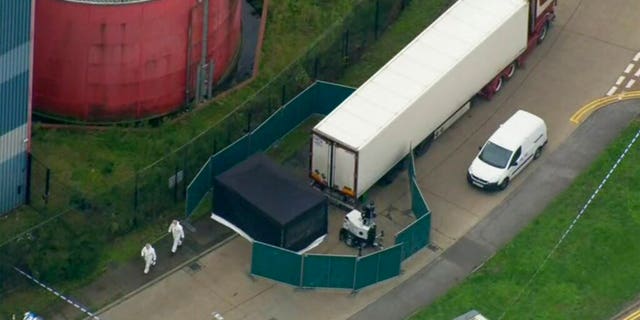 An aerial view as police forensic officers attend the scene after a truck was found to contain a large number of dead bodies, in Thurock, South England, Wednesday Oct. 23, 2019. (UK Pool via AP)