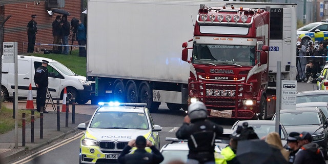 Police escort the truck, that was found to contain a large number of dead bodies, as they move it from an industrial estate in Thurrock, south England, Wednesday Oct. 23, 2019. 