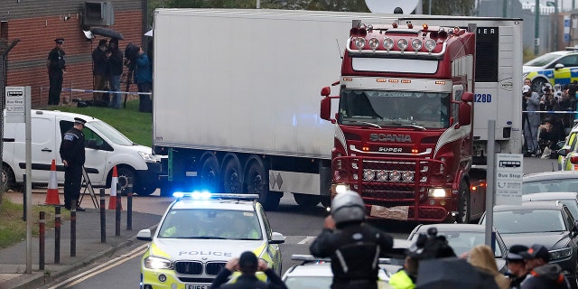 Police escort the truck, that was found to contain a large number of dead bodies, as they move it from an industrial estate in Thurrock, south England, Wednesday Oct. 23, 2019. 