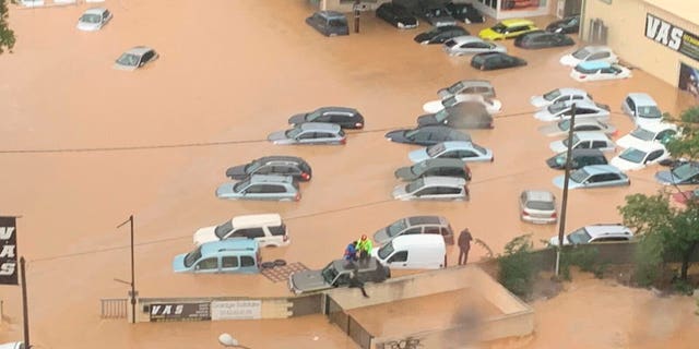 This Oct. 23, 2019 image made by Twitter user @SDIS34 shows cars flooded in the southern France. France's Interior ministry says three people have been killed in torrential rains that flooded towns and villages in southern France this week.