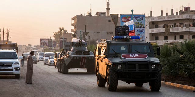 Russian forces patrol in the city of Amuda, north Syria, Thursday, Oct. 24, 2019. Syrian forces, Russian military advisers and military police are being deployed in a zone 30 kilometers (19 miles) deep along much of the northeastern border, under an agreement reached Tuesday by Russia and Turkey.