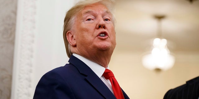 President Donald Trump speaks about attending the World Series as he departs a Presidential Medal of Freedom ceremony for auto racing great Roger Penske in the Oval Office of the White House, Thursday in Washington. (AP Photo/Alex Brandon)