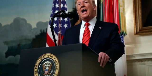 President Donald Trump speaks in the Diplomatic Room of the White House Sunday. (AP Photo/Andrew Harnik)