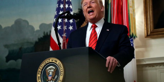 President Donald Trump speaks in the Diplomatic Room of the White House Sunday.  (AP Photo/Andrew Harnik)