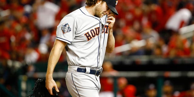 Houston Astros starting pitcher Gerrit Cole walks to the dugout after the third inning of Game 5 of the baseball World Series against the Washington Nationals Sunday, Oct. 27, 2019, in Washington. 