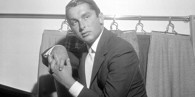 This July 31, 1957 File photo shows actor and sportswear executive Robert Evans, shown in his office in New York.