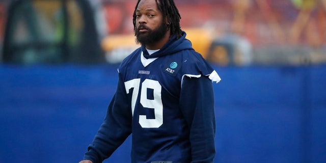 Dallas Cowboys defensive lineman Michael Bennett (79) walks onto the field for an NFL football team practice in Frisco, Texas on Tuesday. The Cowboys acquired Bennett from the New England Patriots for a conditional late-round draft pick in 2021. (AP Photo/LM Otero)