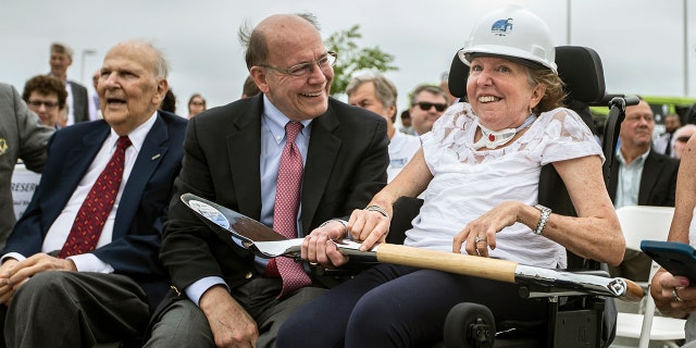 Former U.S. Sen. Kay Hagan, right, smiles with her husband, Chip Hagan, as she wears a hard hat during the ground breaking for a new, 180-foot-tall air traffic control tower at Piedmont Triad International Airport in Greensboro, N.C., on Wednesday, June 5, 2019. Hagan, who served in the Senate from 2008 through 2014, died Monday at 66.