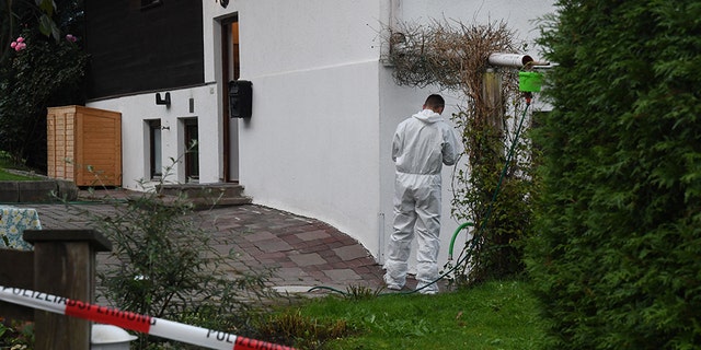 A forensic expert of the police secures the crime scene around a house in Kitzbuehel, Austria, where five people were killed on October 6, 2019.