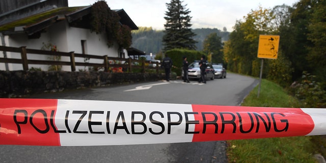 Policemen secure the crime scene around a house in Kitzbuehel, Austria, where five people were killed on October 6, 2019.