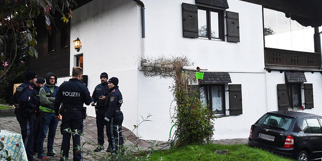 Policemen secure the crime scene around a house in Kitzbuehel, Austria, where five people were killed on October 6, 2019.