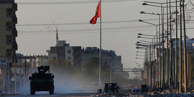 A Turkish police armored vehicle patrols the town of Akcakale, Sanliurfa province, southeastern Turkey, at the border with Syria, Saturday, Oct. 12, 2019. The towns along Turkey's border with northeastern Syria have been on high alert after dozens of mortars fired from Kurdish-held Syria landed, killing several civilians. (AP Photo/Lefteris Pitarakis)