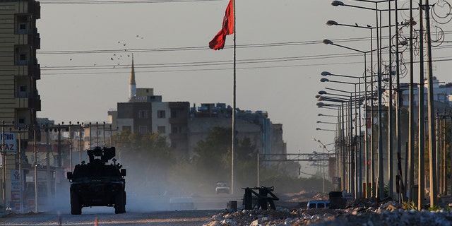 A Turkish police armored vehicle patrols the town of Akcakale, Sanliurfa province, southeastern Turkey, at the border with Syria, Saturday, Oct. 12, 2019. The towns along Turkey's border with northeastern Syria have been on high alert after dozens of mortars fired from Kurdish-held Syria landed, killing several civilians. (AP Photo/Lefteris Pitarakis)
