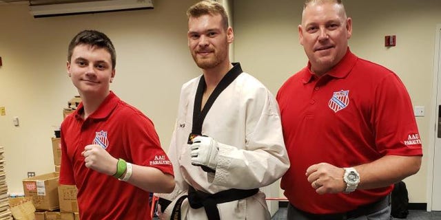 From left to right: Austin Olsen, his training partner, Evan Medell, currently ranked 1st in the world for para taekwondo and preparing for the 2020 Paralympic Games, and coach Brad Deminck.