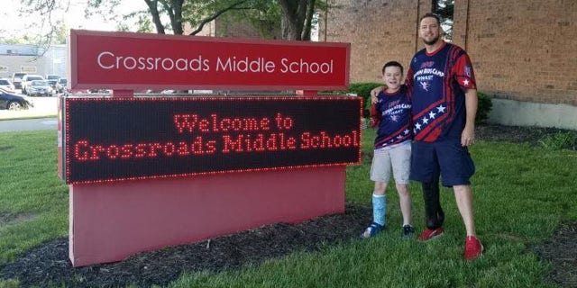 Austin Olsen pictured with Cody Rice of USA Patriots. The two spoke at the public school where Austin was once bullied.