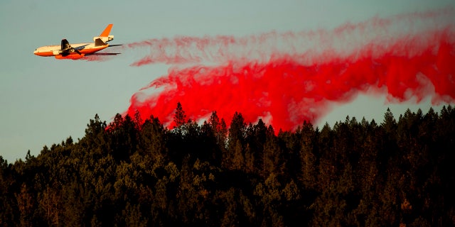 An air tanker drops retardant while battling the Kincade Fire near Healdsburg, Calif., on Tuesday, Oct. 29, 2019.