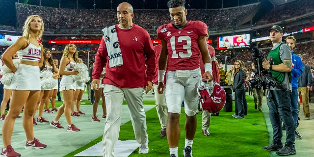 Alabama quarterback Tua Tagovailoa (13) walks off the field hurt against Tennessee during the first half of an NCAA college football game, Saturday, Oct. 19, 2019, in Tuscaloosa, Ala. (AP Photo/Vasha Hunt)