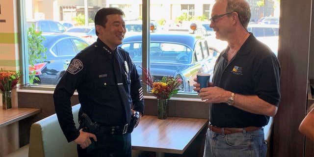 An officer is seen at a McDonald's in Hawthorne, Calif., on 2019's National Coffee With a Cop Day.