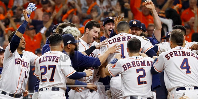 Houston Astros' Carlos Correa celebrates with teammates after his walk-off home run against the New York Yankees during the 11th inning in Game 2 of baseball's American League Championship Series Sunday, Oct. 13, 2019, in Houston. (AP Photo/Eric Gay)