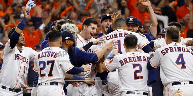 Houston Astros' Carlos Correa celebrates with teammates after his walk-off home run against the New York Yankees during the 11th inning in Game 2 of baseball's American League Championship Series Sunday, Oct. 13, 2019, in Houston. (AP Photo/Eric Gay)