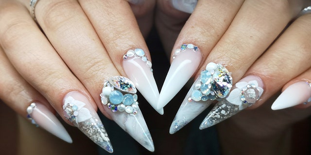 Bride Charlotte Walton displays her wedding day manicure, pictured, which featured some of her father's ashes in the design.