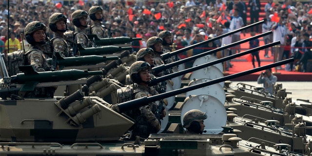 Military vehicles roll down during a parade to commemorate the 70th anniversary of the founding of Communist China in Beijing, Tuesday, Oct. 1, 2019. (AP Photo/Ng Han Guan)