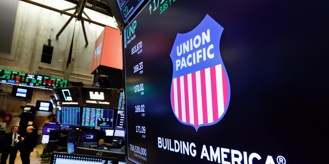 FILE - In this Sept. 13, 2019, file photo the logo for Union Pacific appears above a trading post on the floor of the New York Stock Exchange. Union Pacific Corp. reports financial results Thursday, Oct. 17. (AP Photo/Richard Drew, File)