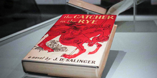 A copy of the 1951 novel "The Catcher in the Rye" is part of a J.D. Salinger exhibit being installed at the New York Public Library, Wednesday, Oct. 16, 2019, in New York. The exhibit, titled "JD Salinger," opens Friday and draws from archives made available by the author's family and helps mark the centennial of his birth. (AP Photo/Bebeto Matthews)