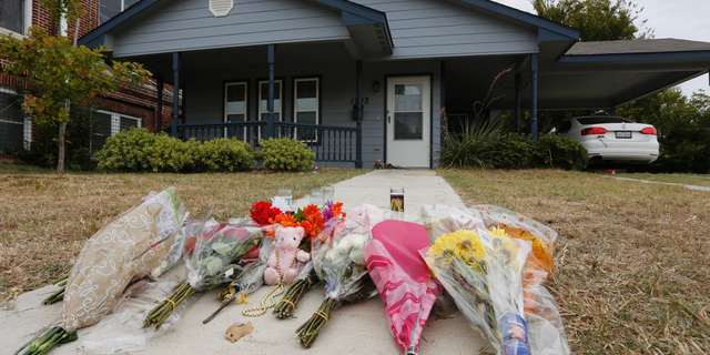 FILE - In this Monday, Oct. 14, 2019 photo, flowers lie on the sidewalk in front of the house in Fort Worth, Texas, where a white Fort Worth police officer Aaron Dean shot and killed Atatiana Jefferson, a black woman, through a back window of her home. Dean resigned before he could be compelled to undergo questioning. After a police officer fatally shoots someone, it can take days or even weeks before the public or his supervisors hear the officer’s version of what happened. (AP Photo/David Kent, File)